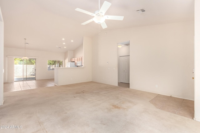 unfurnished room with ceiling fan, light colored carpet, and lofted ceiling