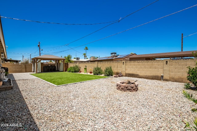 view of yard featuring a gazebo and an outdoor fire pit