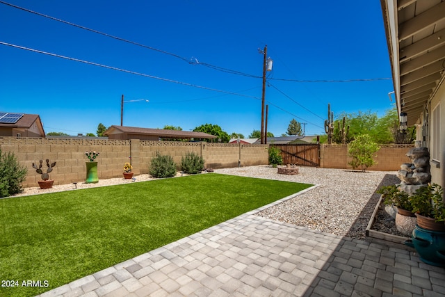 view of yard featuring a patio and an outdoor fire pit