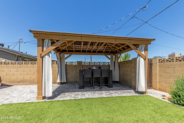 view of patio featuring a gazebo and exterior bar