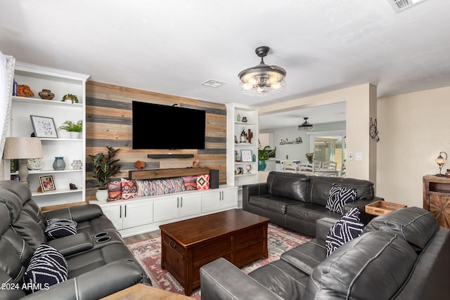 living room with wood-type flooring and wood walls