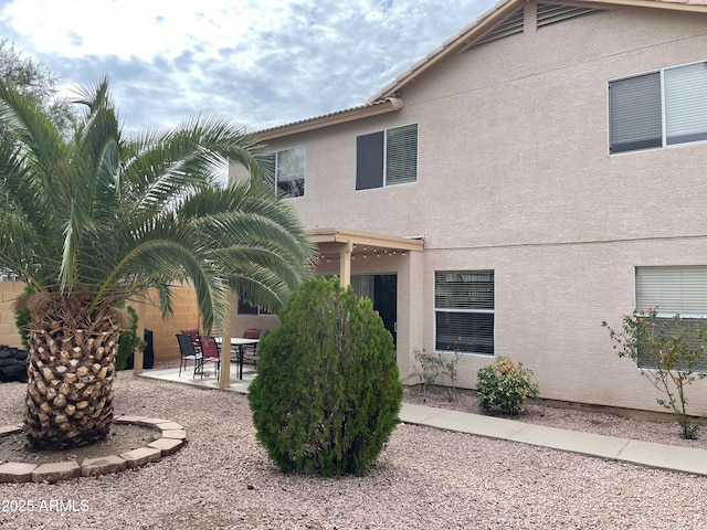 back of house with a patio