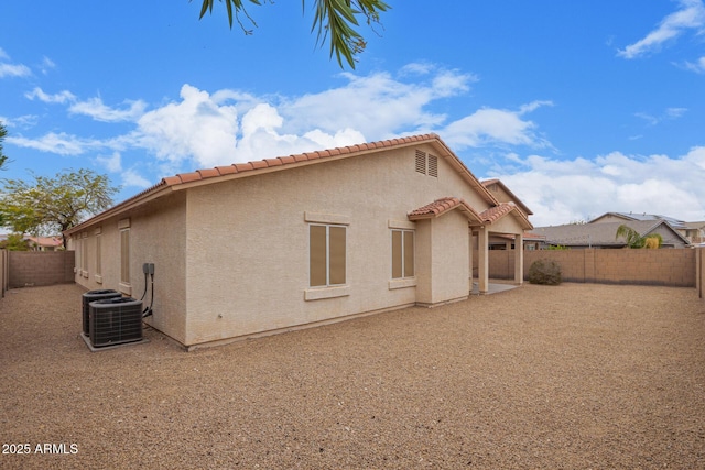 rear view of house with a patio and central AC unit