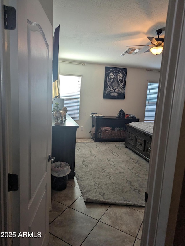 bathroom with tile patterned floors and ceiling fan