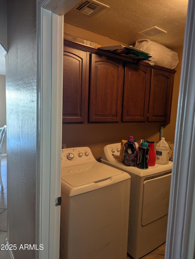 laundry area featuring cabinets and independent washer and dryer