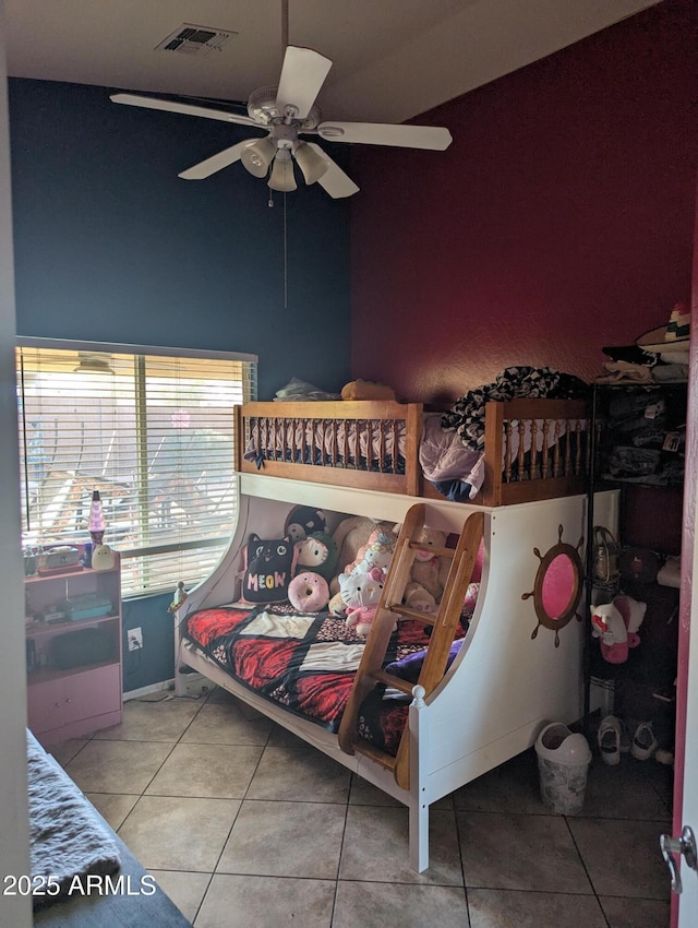 bedroom featuring ceiling fan and tile patterned flooring