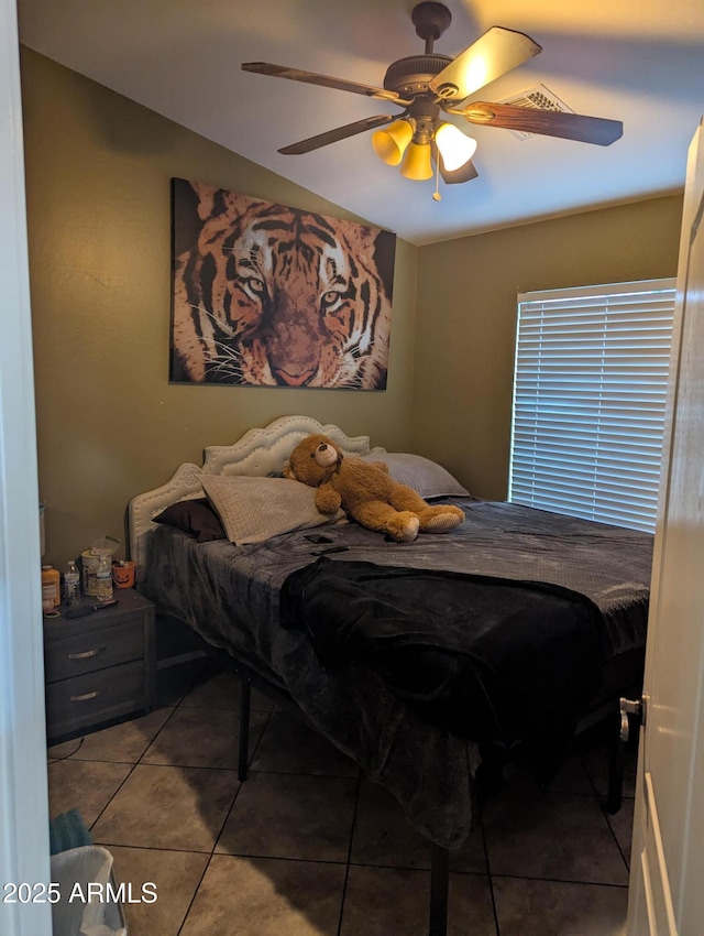 tiled bedroom featuring ceiling fan