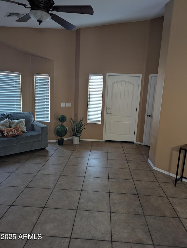 foyer entrance featuring tile patterned flooring, lofted ceiling, and ceiling fan