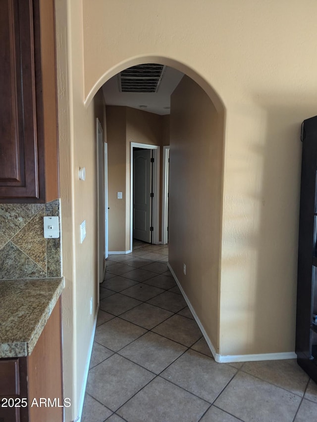 hallway with light tile patterned floors