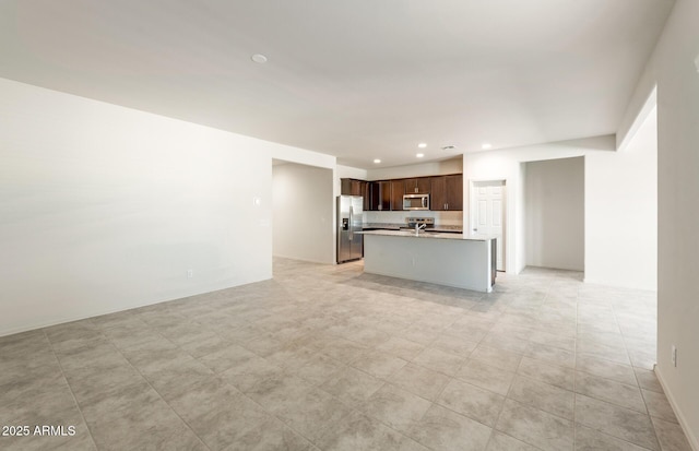 unfurnished living room featuring recessed lighting