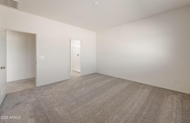 unfurnished room featuring baseboards, visible vents, and light colored carpet