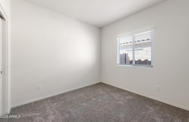 spare room with carpet floors and baseboards