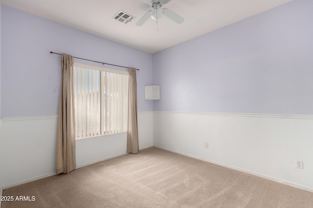 unfurnished room with ceiling fan and light carpet