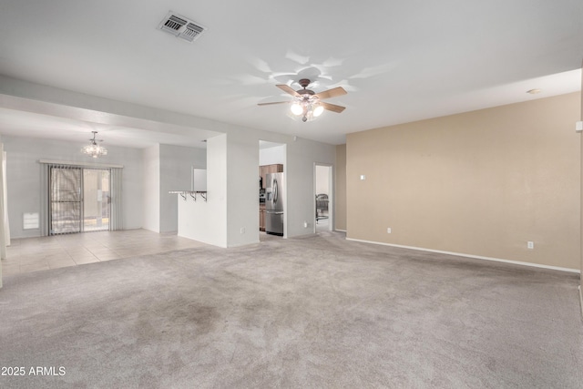 empty room with light carpet and ceiling fan with notable chandelier