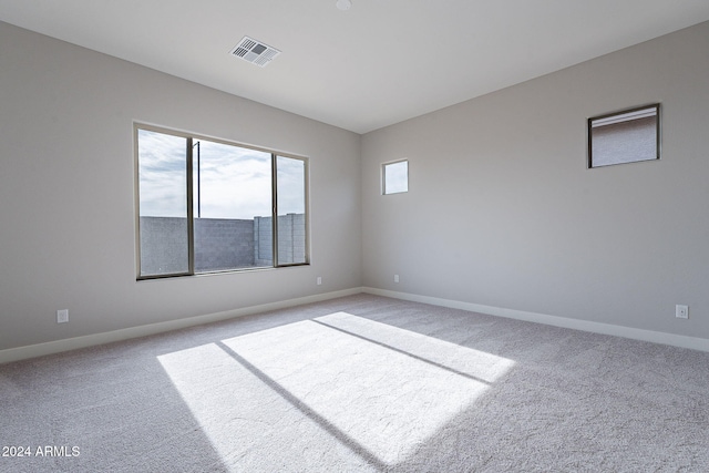 unfurnished room with light colored carpet