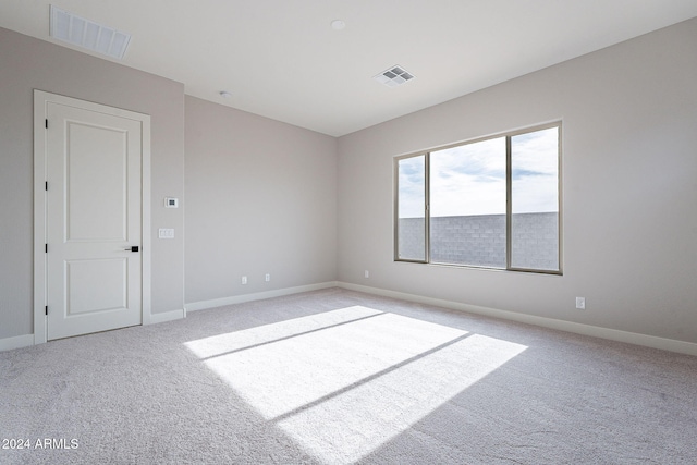 spare room with light colored carpet