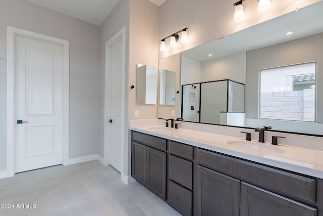 bathroom featuring tile patterned flooring, vanity, and walk in shower