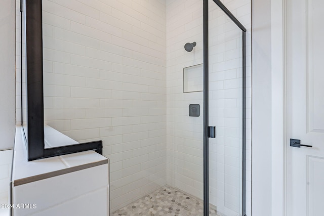 bathroom with a shower with door