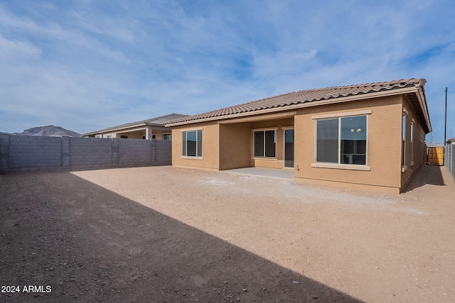 rear view of property featuring a patio