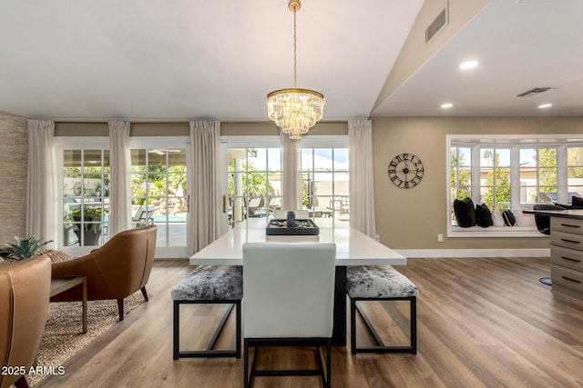 dining room with a chandelier, visible vents, plenty of natural light, and wood finished floors