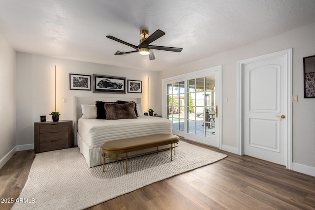 bedroom featuring access to outside, wood finished floors, and baseboards