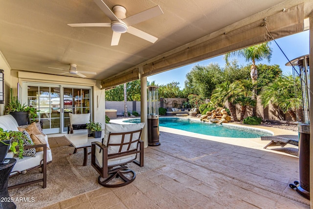 view of patio featuring a fenced backyard, a fenced in pool, and a ceiling fan