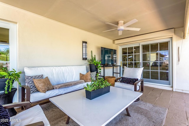 view of patio with an outdoor living space and a ceiling fan