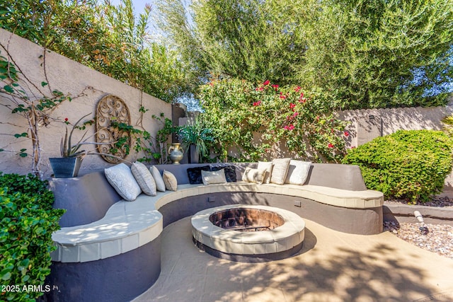 view of patio featuring an outdoor living space with a fire pit and a fenced backyard