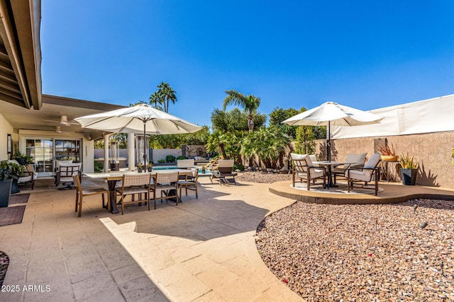 view of patio / terrace with a fenced backyard, a fenced in pool, and outdoor dining space