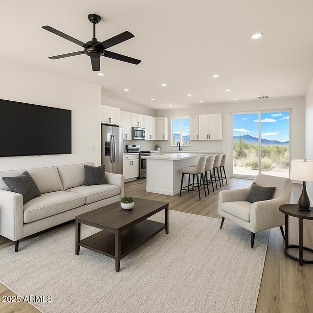 16025 E Rancho Laredo Dr, Scottsdale, AZ 85262 - living room with light wood finished floors, recessed lighting, and ceiling fan