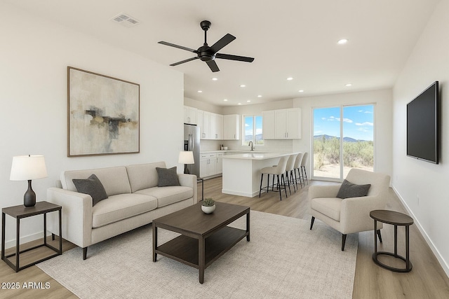 16025 E Rancho Laredo Dr, Scottsdale, AZ 85262 - living area with light wood-type flooring, a ceiling fan, recessed lighting, and baseboards