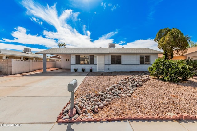 ranch-style house featuring a carport and central air condition unit