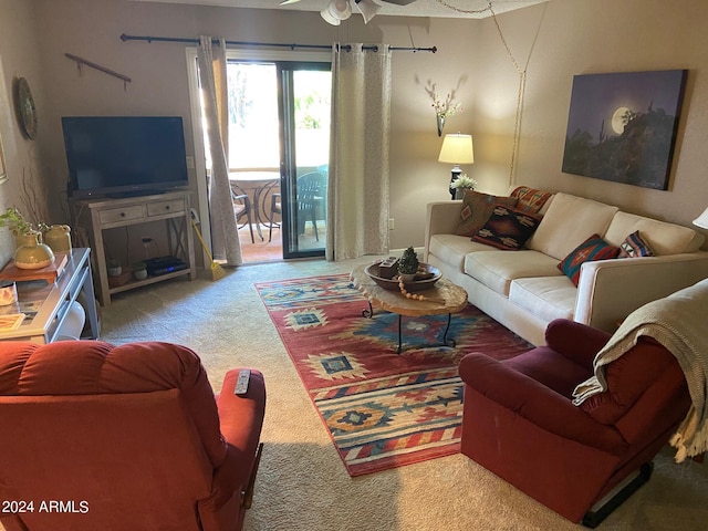 living room with ceiling fan and carpet