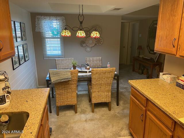 carpeted dining area with sink