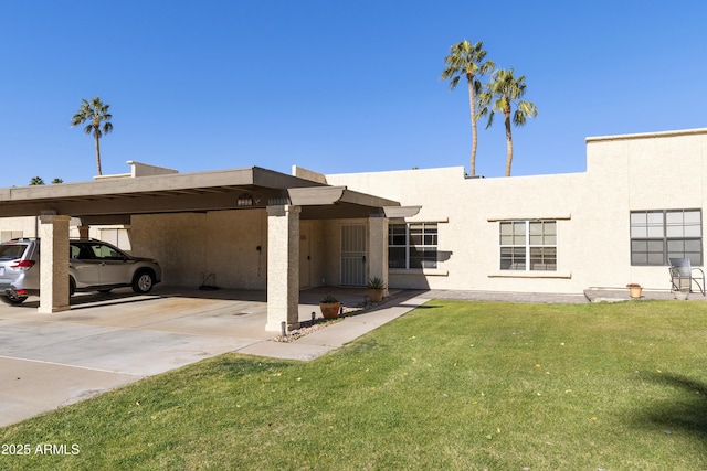 exterior space featuring a front lawn and a carport