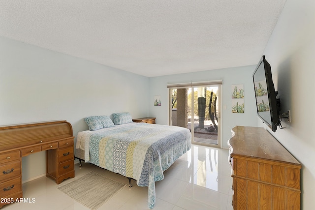 tiled bedroom featuring access to exterior and a textured ceiling