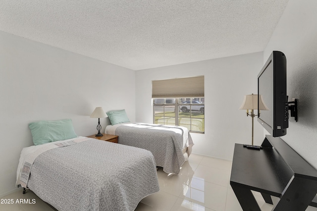 bedroom with light tile patterned flooring and a textured ceiling