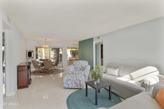 living room with a textured ceiling and light tile patterned floors