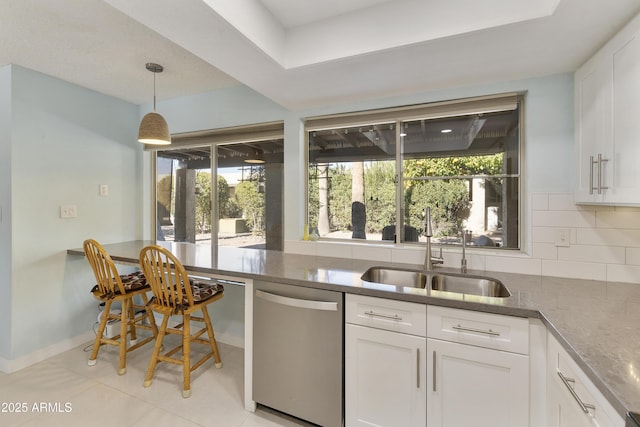 kitchen with sink, white cabinetry, decorative backsplash, and dishwasher