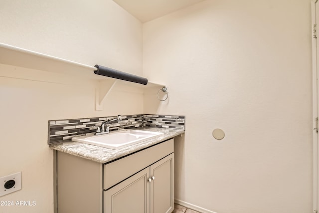 bathroom featuring vanity and tasteful backsplash