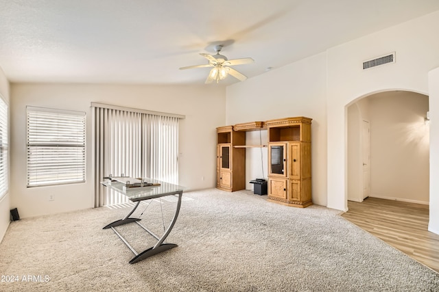 unfurnished office featuring hardwood / wood-style flooring, vaulted ceiling, and ceiling fan