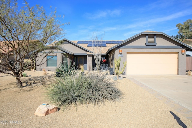 ranch-style home with driveway, a garage, solar panels, and stucco siding