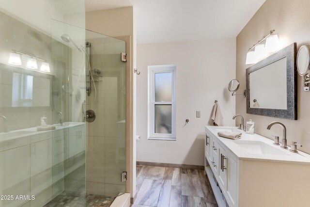 bathroom featuring a sink and a shower stall