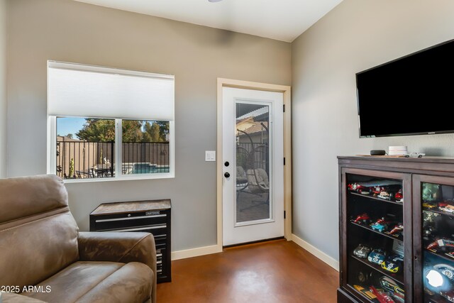 interior space featuring baseboards and concrete flooring