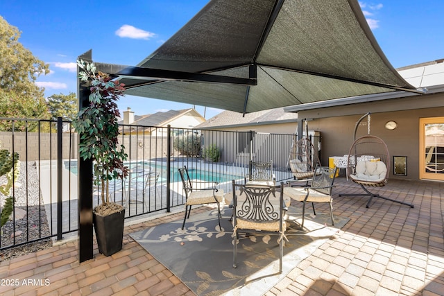 view of patio featuring fence and a fenced in pool