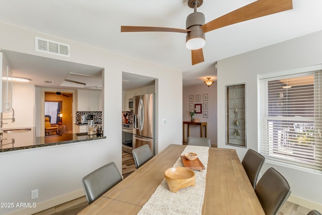 dining space with a ceiling fan and visible vents