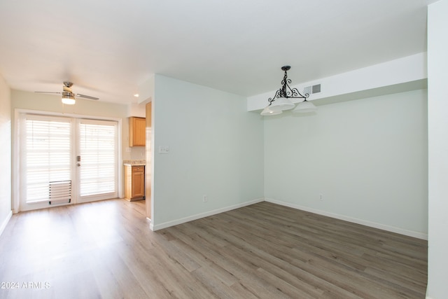 spare room with ceiling fan and wood-type flooring