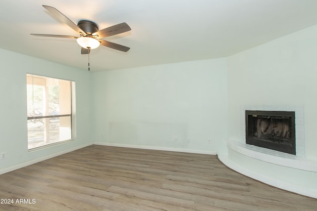 unfurnished living room with light hardwood / wood-style floors and ceiling fan