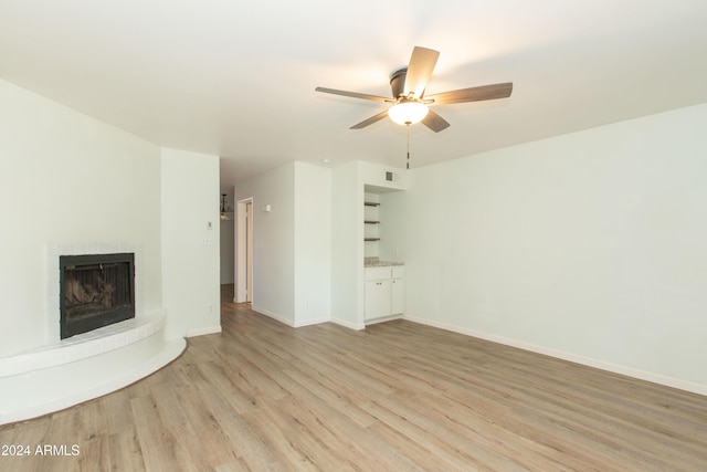 unfurnished living room featuring light hardwood / wood-style floors and ceiling fan