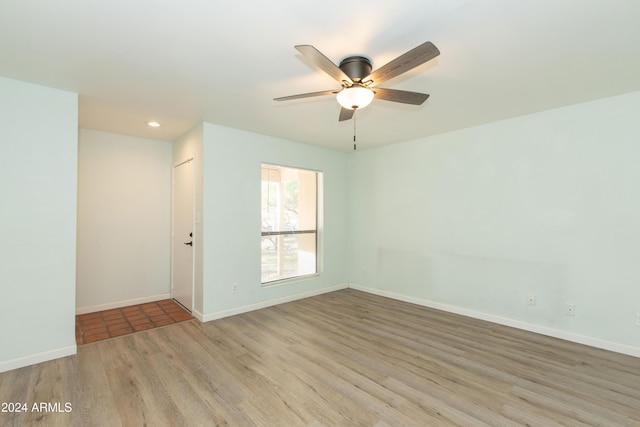 empty room featuring ceiling fan and light hardwood / wood-style flooring